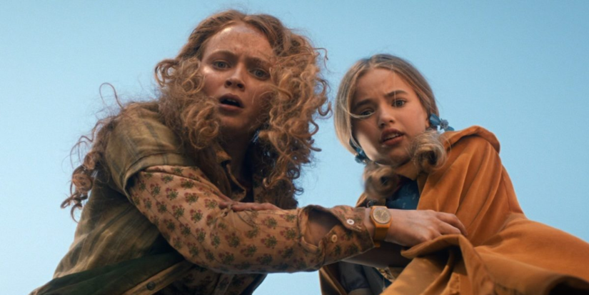 Holly and Max looking down at the camera in Stranger Things.