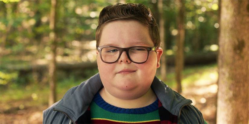 Closeup of Derek smirking and looking to the side.