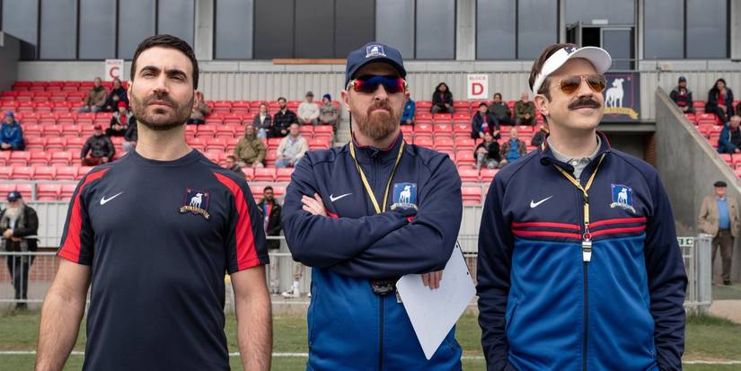 Roy, Beard, and Ted Lasso standing next to each other on the pitch