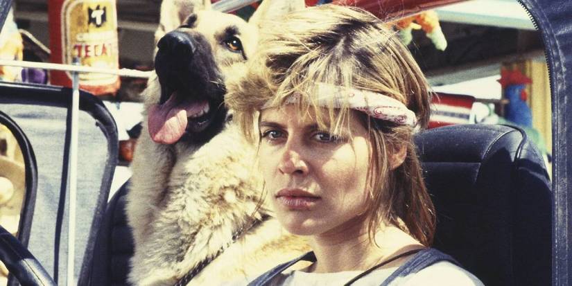Sarah Connor in 'The Terminator' (1984) sitting inside a car next to a dog.