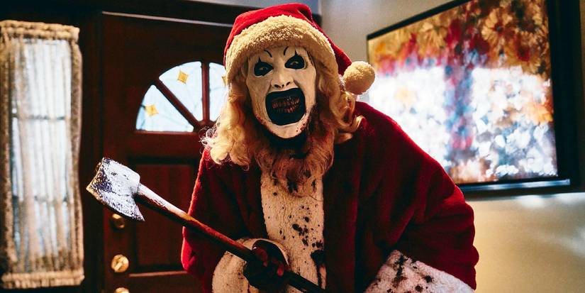 Art the Clown dressed as Santa Claus wielding an axe in Terrifier 3