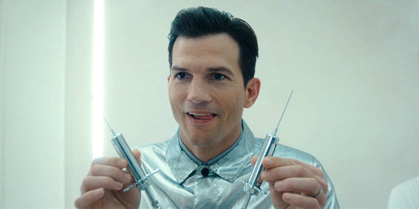 Ashton Kutcher in a shiny silver shirt holds two syringes in 'The Beauty'.