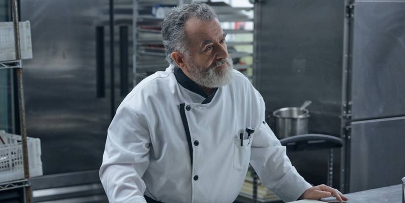 Saul Rubinek as Victor wearing a chef's jacket in a kitchen on 'The Copenhagen Test.'