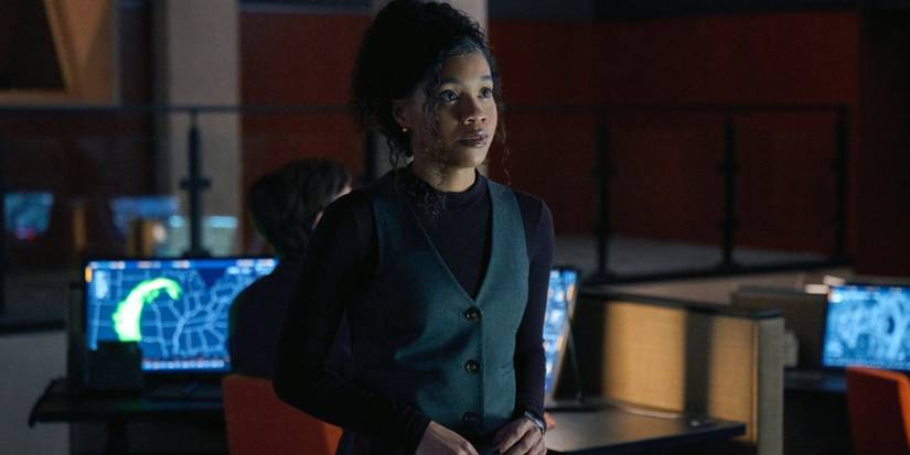 Sinclair Daniel as Parker in a dark office staring ahead with computers behind in 'The Copenhagen Test.'