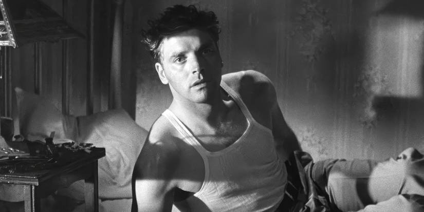 Burt Lancaster getting up from a bed in The Killers