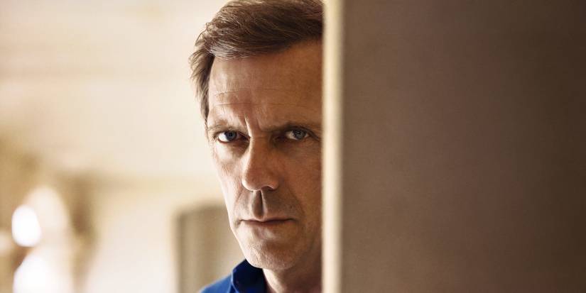 Roper looking around a corner with narrowed eyes in The Night Manager Season 1