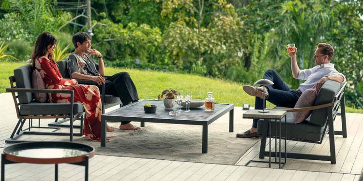 Roxana, Teddy, and Pine sitting outside and talking in The Night Manager Season 2 Episode 2