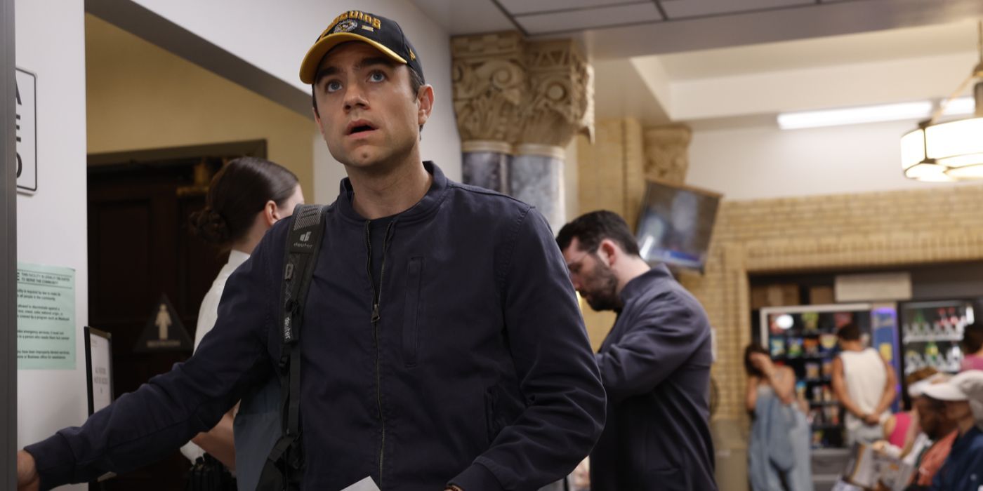 Dr. Langdon (Patrick Ball) wearing a hat and looking nervous in 'The Pitt'