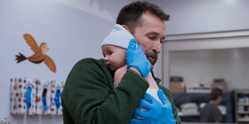 Robby (Noah Wyle) holds a baby on 'The Pitt'