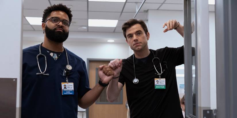 Brandon Mendez Homer and Patrick Ball fist bump while looking through a doorway in The Pitt Season 2.