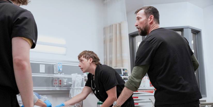 Whitaker and Robby leaning over a patient's bedside and anxiously looking at his status in The Pitt Season 2 Episode 4
