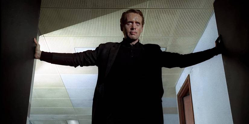 Number Six throwing open a set of doors in The Prisoner