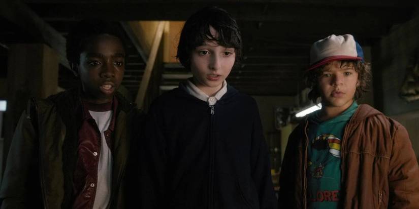 Lucas, Mike, and Dustin stare ahead in surprises in The Weirdo on Maple Street episode of Stranger Things.