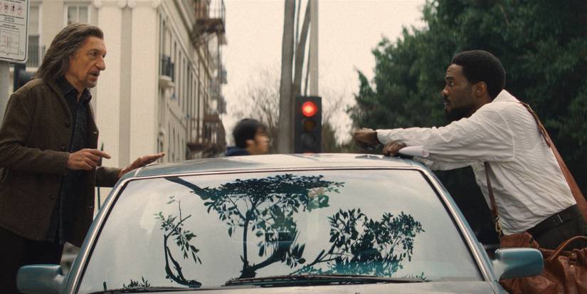 Yahya Abdul-Mateen II and Ben Kingsley talking over a car on a city street in Wonder Man Episode 2.