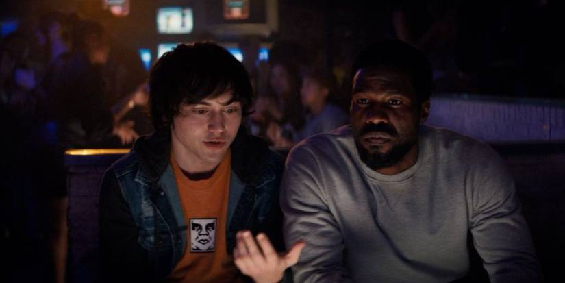 A kid and Simon sitting in a bar talking in Wonder Man Episode 5.