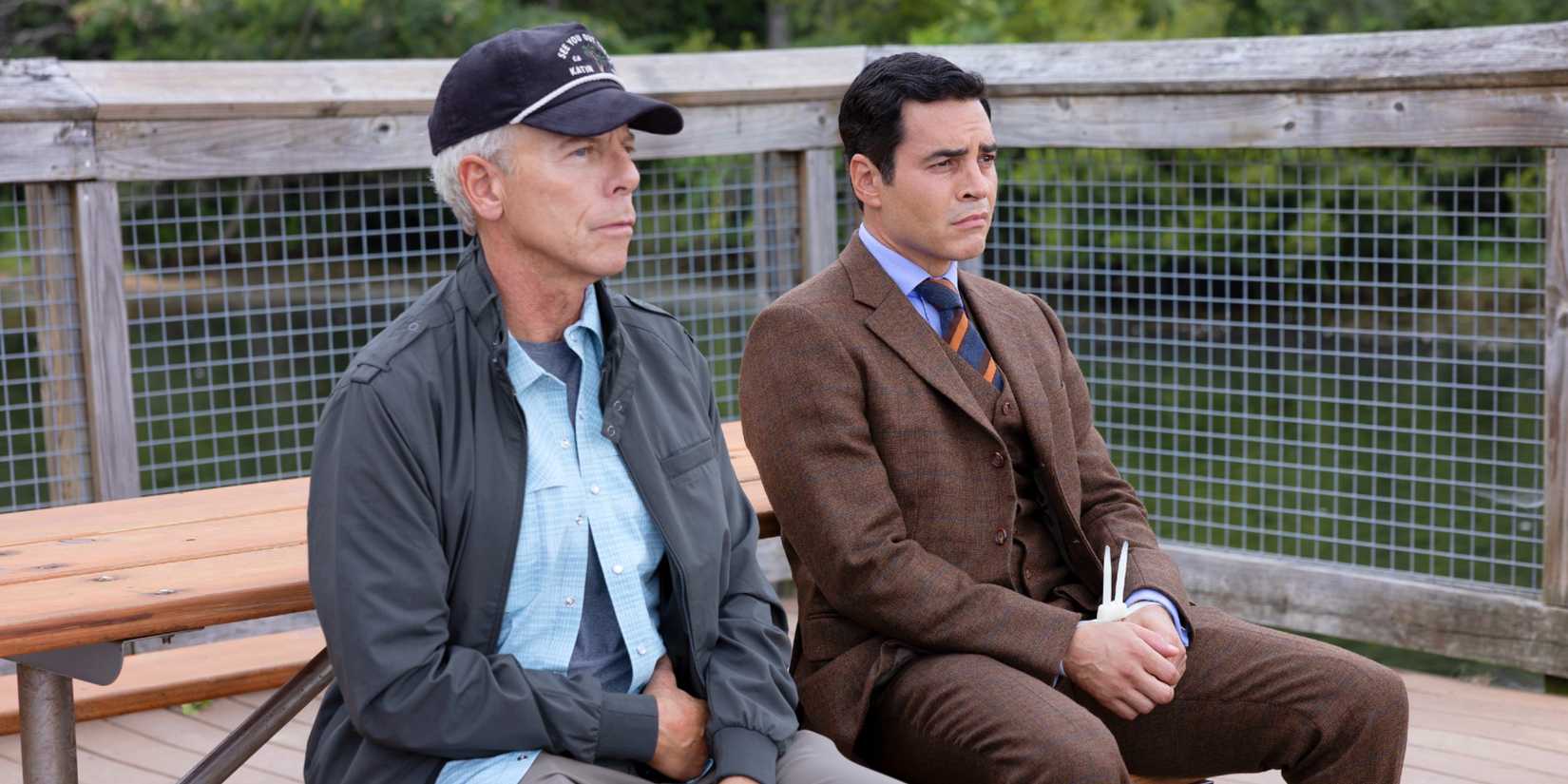 Will Trent and James Ulster sitting together on the pier (Will's wrists are zip-tied) in Will Trent Season 4
