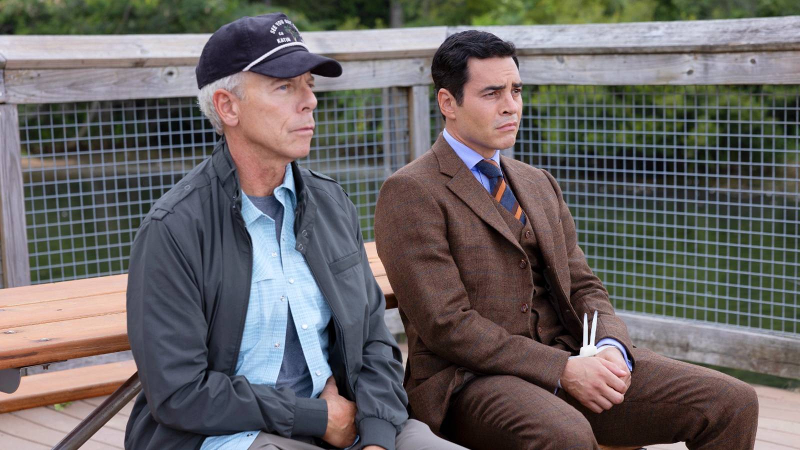Will Trent and James Ulster sitting together on the pier (Will's wrists are zip-tied) in Will Trent Season 4