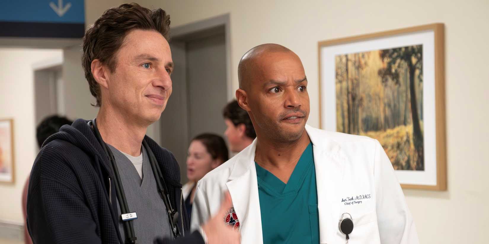 Zach Braff as J.D. standing next to Donald Faison as Turk in Sacred Heart Hospital in the Scrubs revival