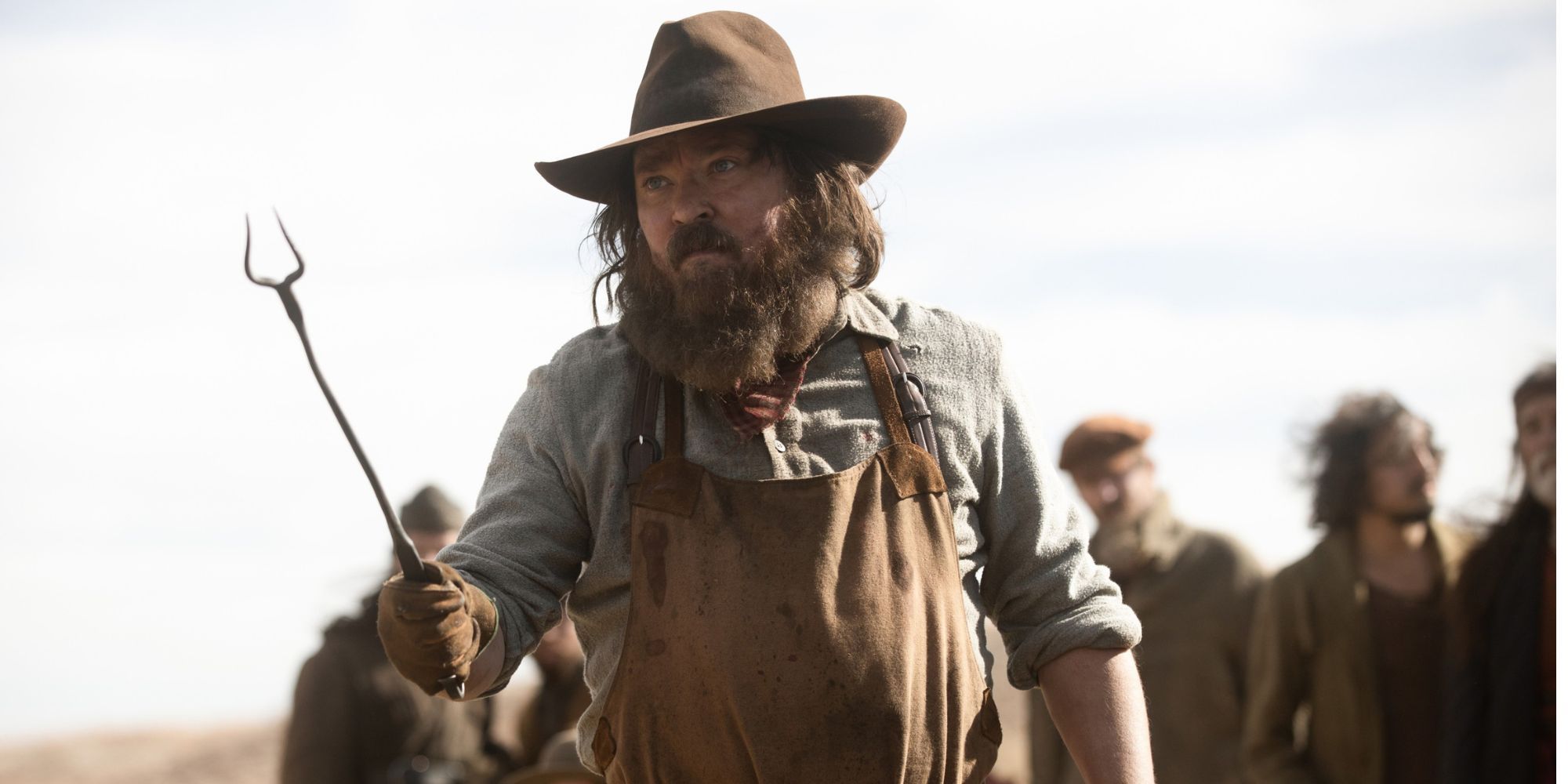 Frontier man wielding pitchfork