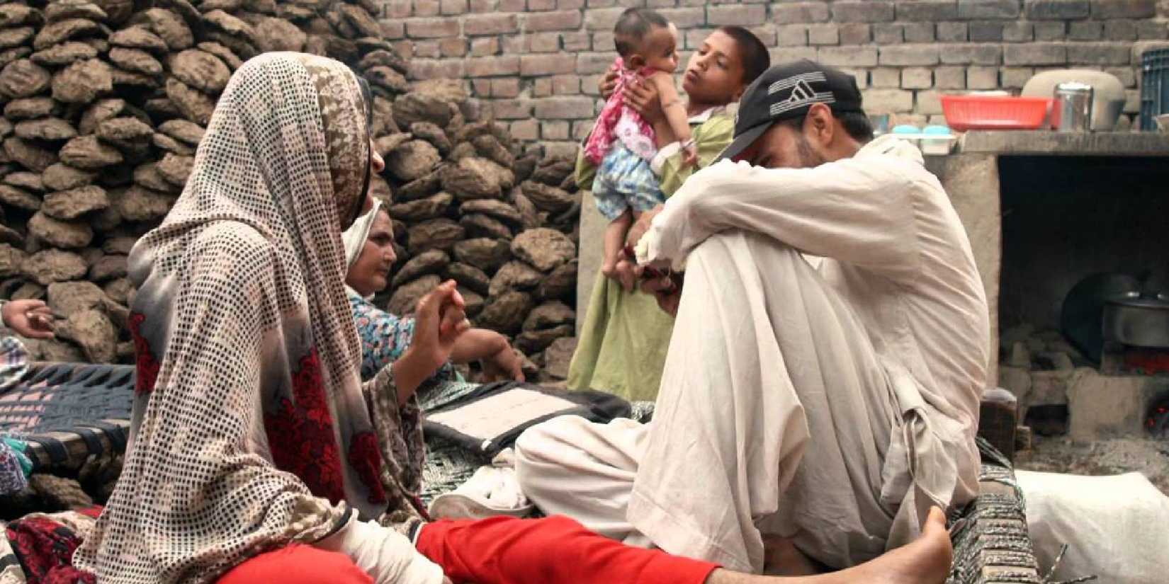 Two people sitting down in A Girl in the River still