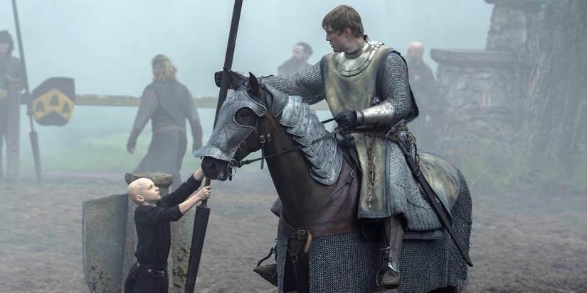 Peter Claffey as Dunk in armor on a horse as Dexter Sol Ansell as Egg helps in A Knight of the Seven Kingdoms