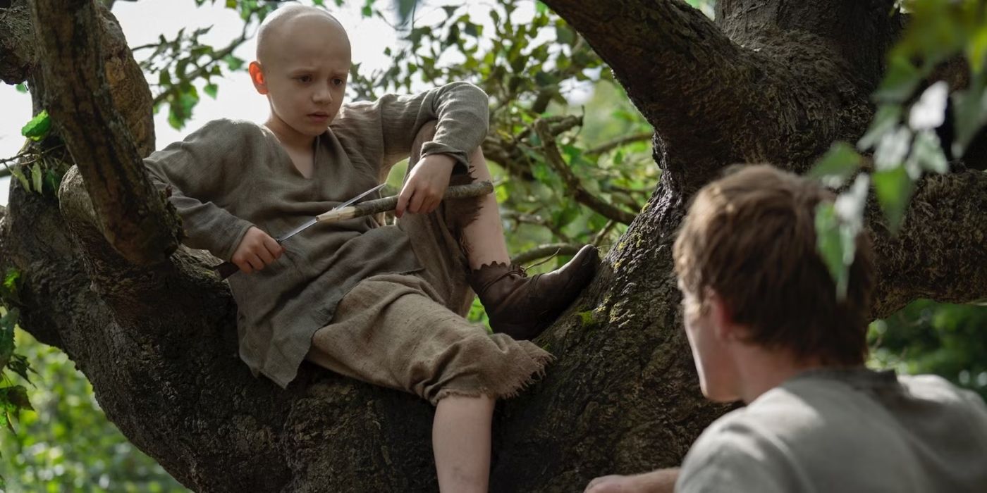 Dexter Sol Ansell as Egg sitting in a tree looking down at Peter Claffey as Dunk in A Knight of the Seven Kingdoms