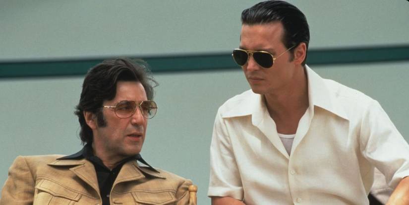 Al Pacino as Lefty sitting next to and speaking with Johnny Depp as Donnie Brasco in Donnie Brasco