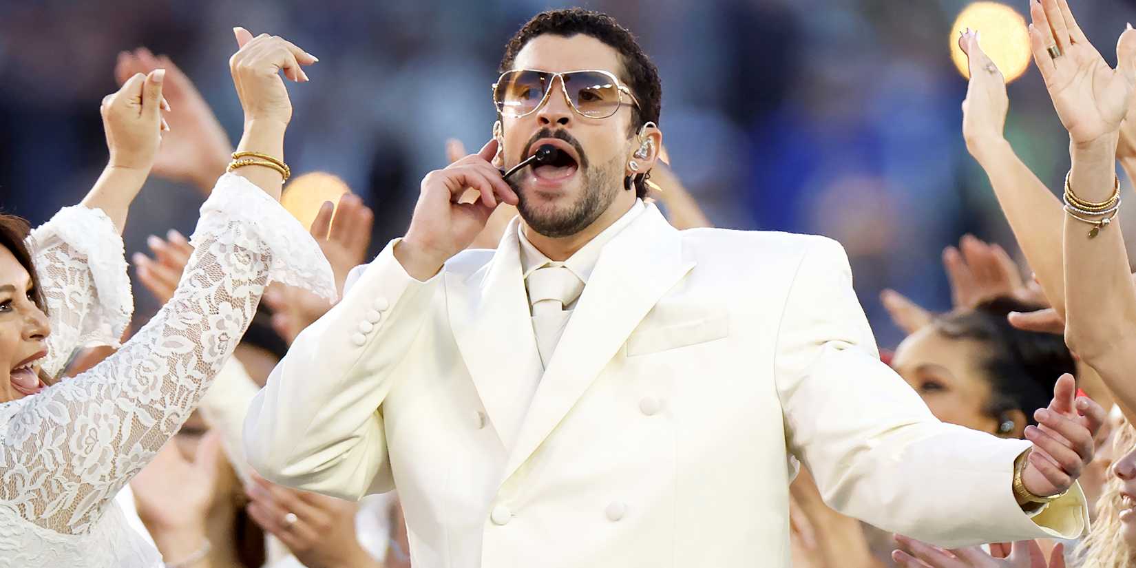 Bad Bunny wears a white suit while performing at the halftime show of the Super Bowl