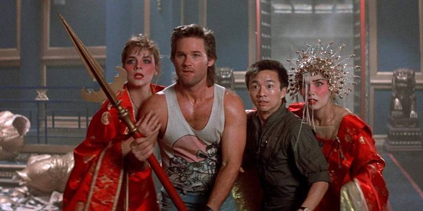 Kurt Russell with three people around him in Big Trouble in Little China.