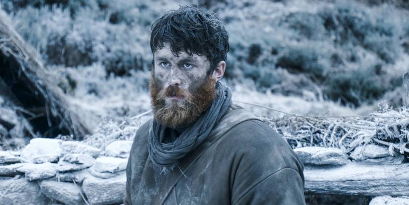 A warrior in a snowy forest looking ahead in Black '47