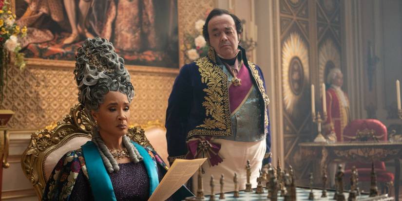 Golda Rosheuvel as the Queen reading a letter with Hugh Sacs as Brimsley in Bridgerton Season 4.