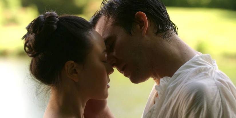 Sophie Baek (Yerin Ha) and Benedict Bridgerton (Luke Thompson) kiss by the lake in 'Bridgerton' Season 4.