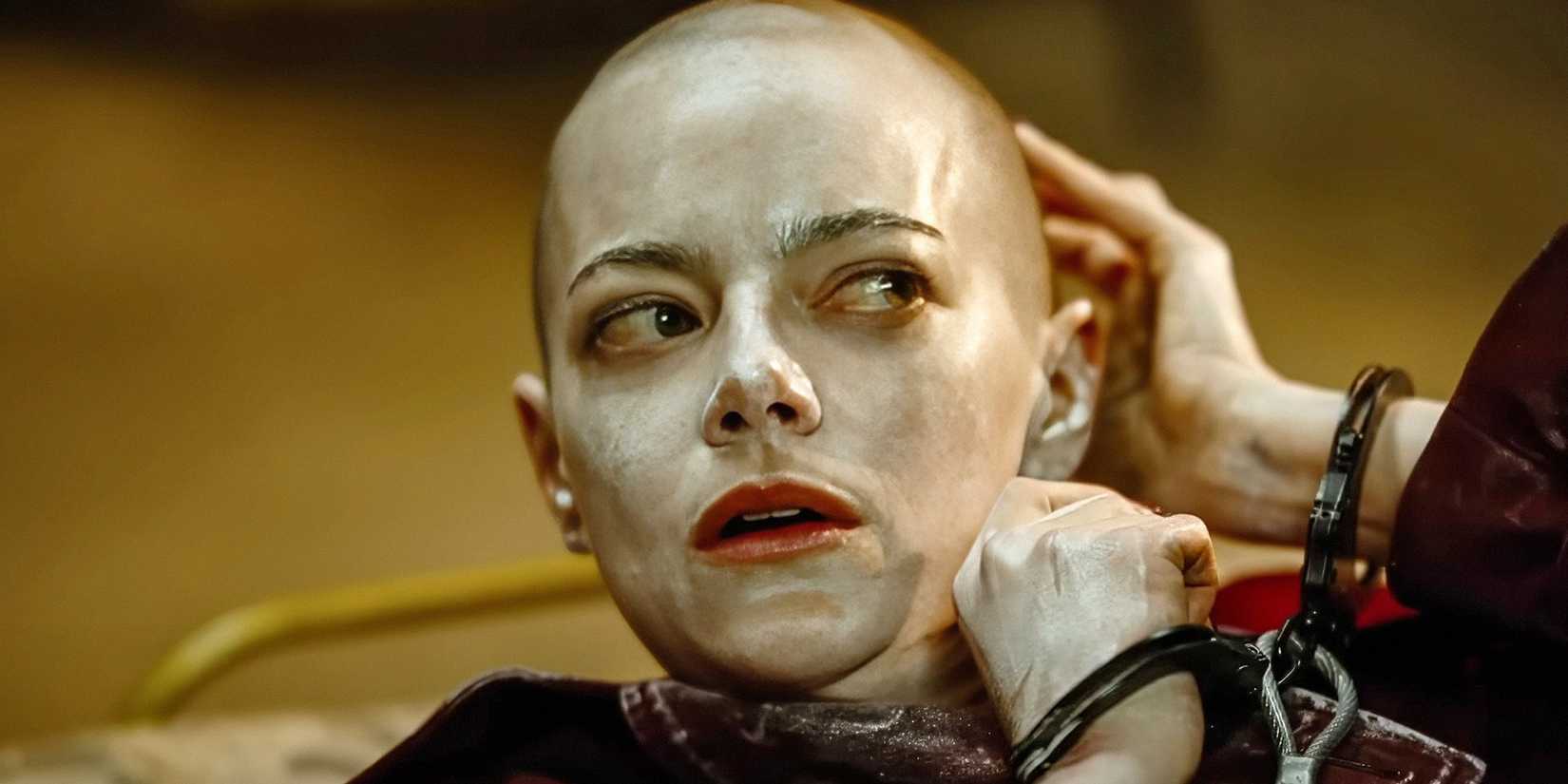 Bald Emma Stone looking confused in Bugonia