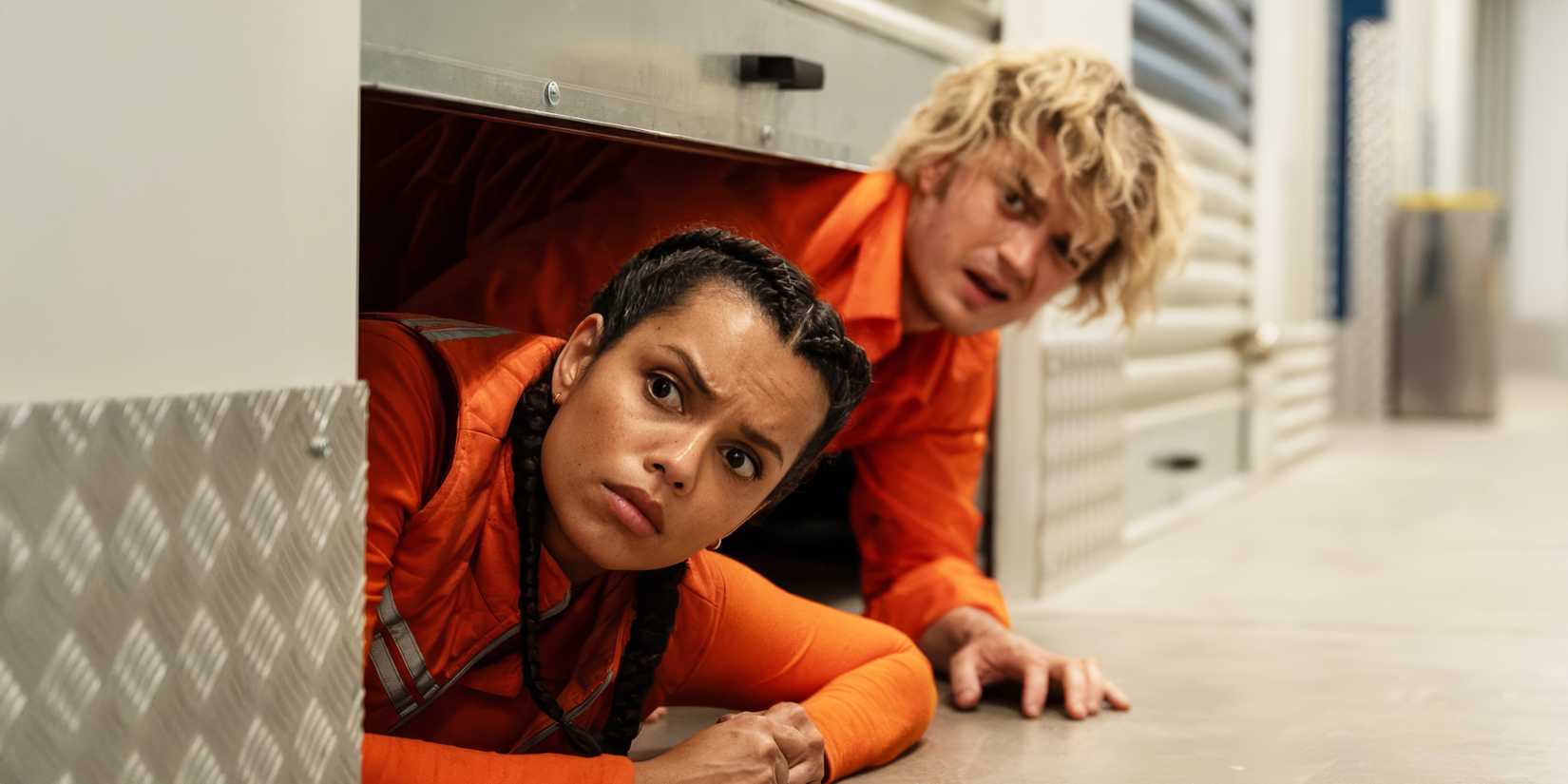 Georgina Campbell and Joe Keery wear orange hazmat suits in 'Cold Storage' image