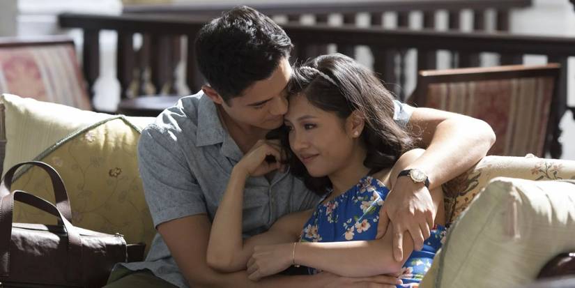 Nick (Henry Golding) and Rachel (Constance Wu) on the couch together in 'Crazy Rich Asians'