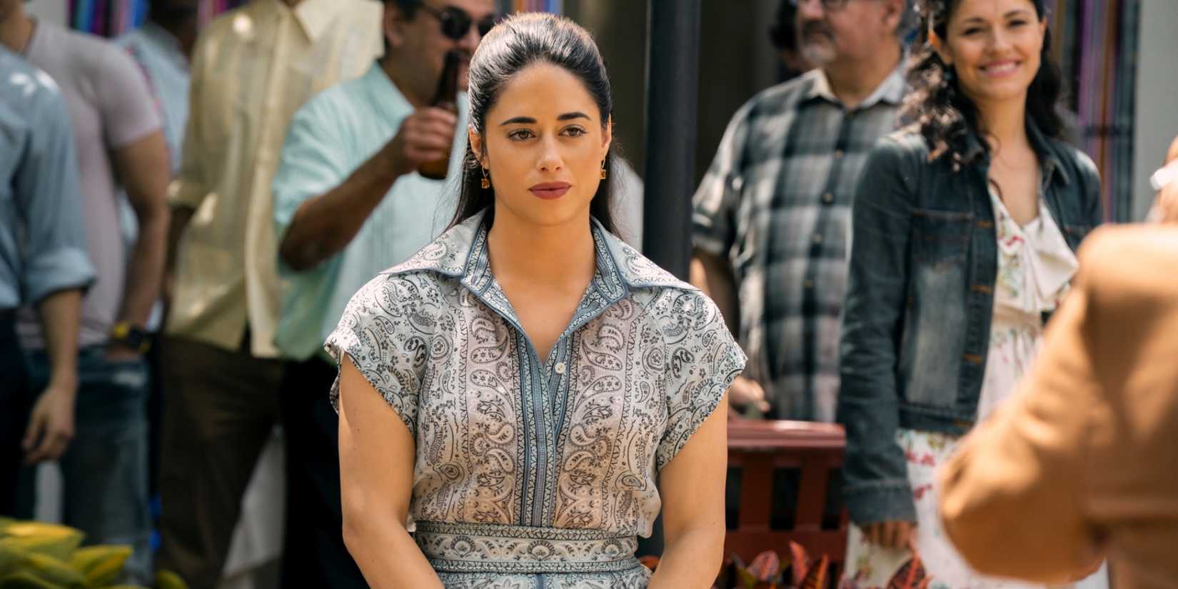 Jeanine Mason as Luz standing outside in a dress with her hair pulled back in Cross Season 2