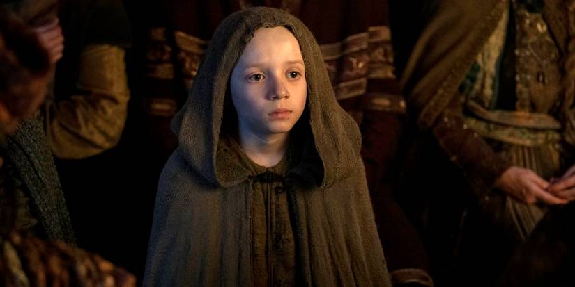 Dexter Sol Ansell as Egg standing in a hooded cloak in A Knight of the Seven Kingdoms