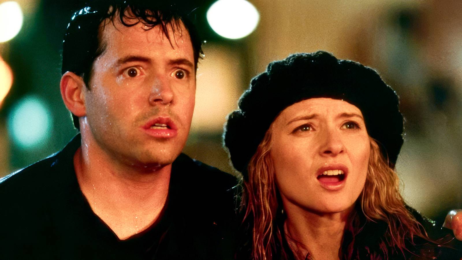 Matthew Broderick and Maria Pitillo stand in the street and look on in shock in Godzilla 1998