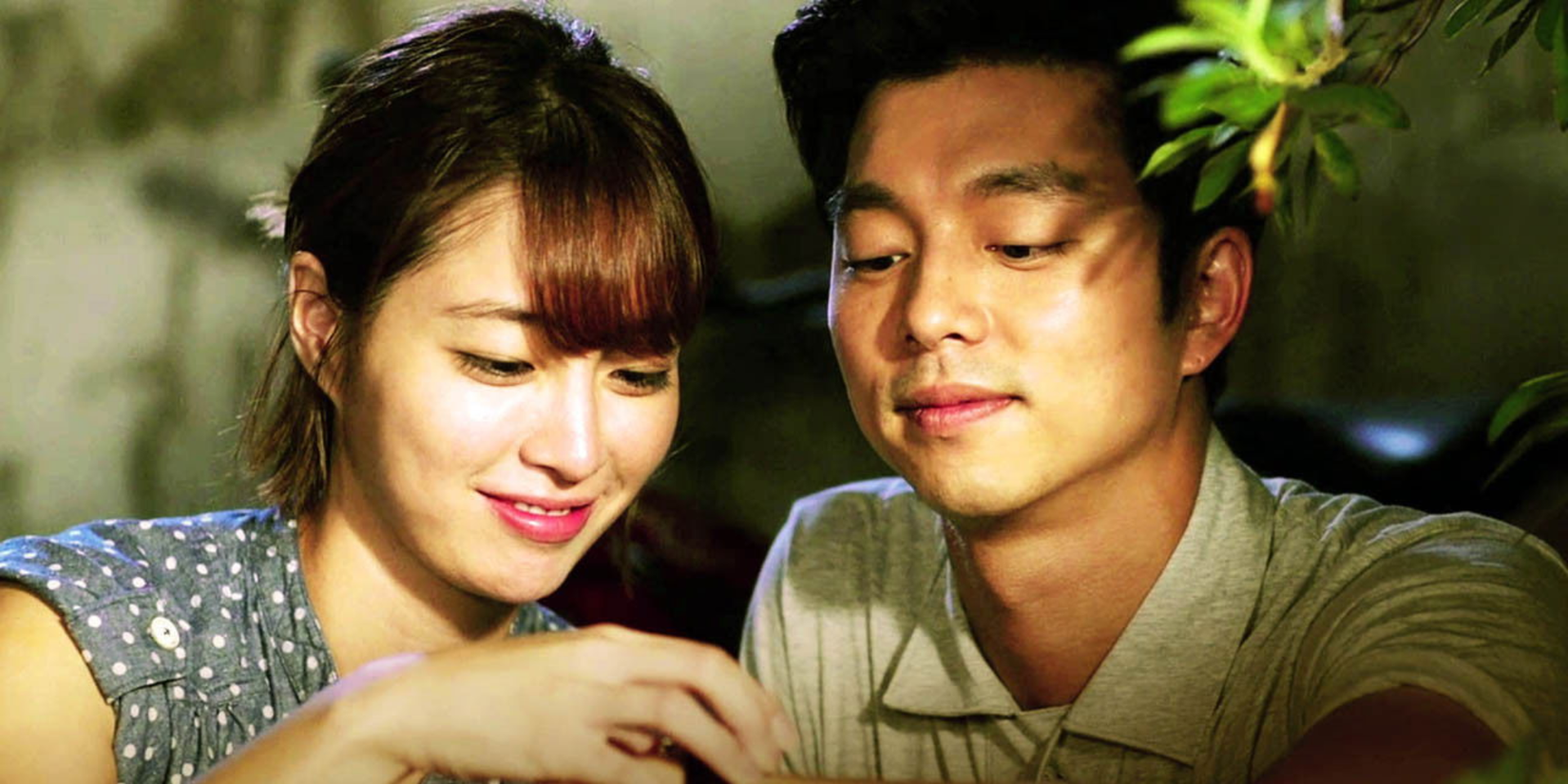 Gong Yoo and a costar smiling near a plant in the Kdrama Big.
