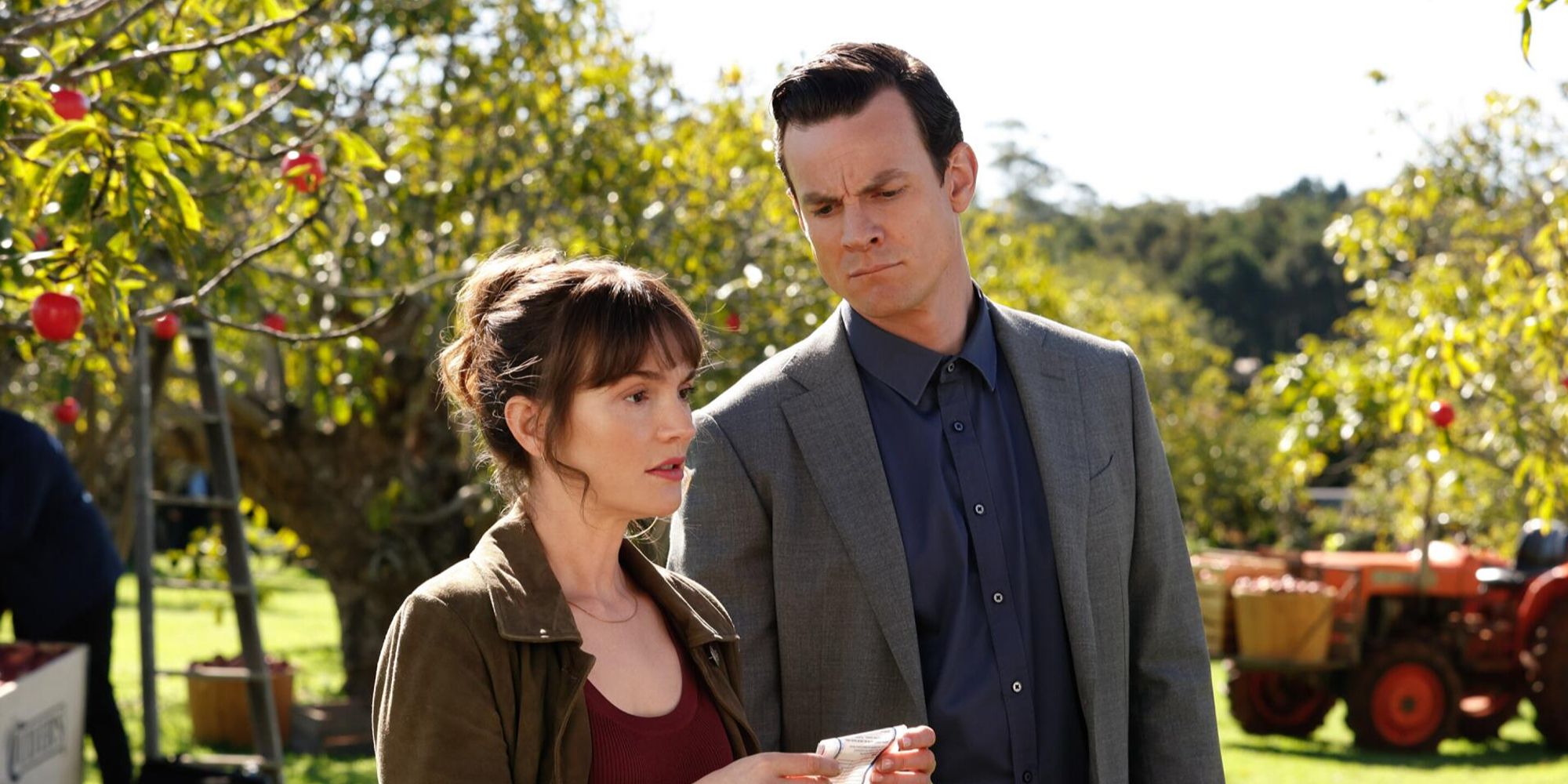 Leighton Meester holding a paper next to Luke Cook in an orchard in Good Cop Bad Cop