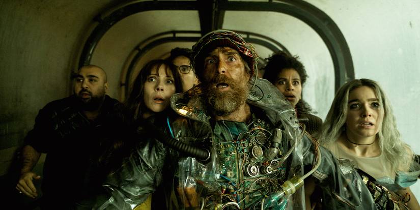 The cast are all gathered behind Sam Rockwell.