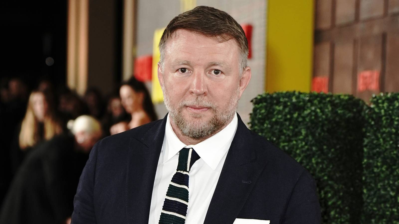 Guy Ritchie in a suit on the red carpet