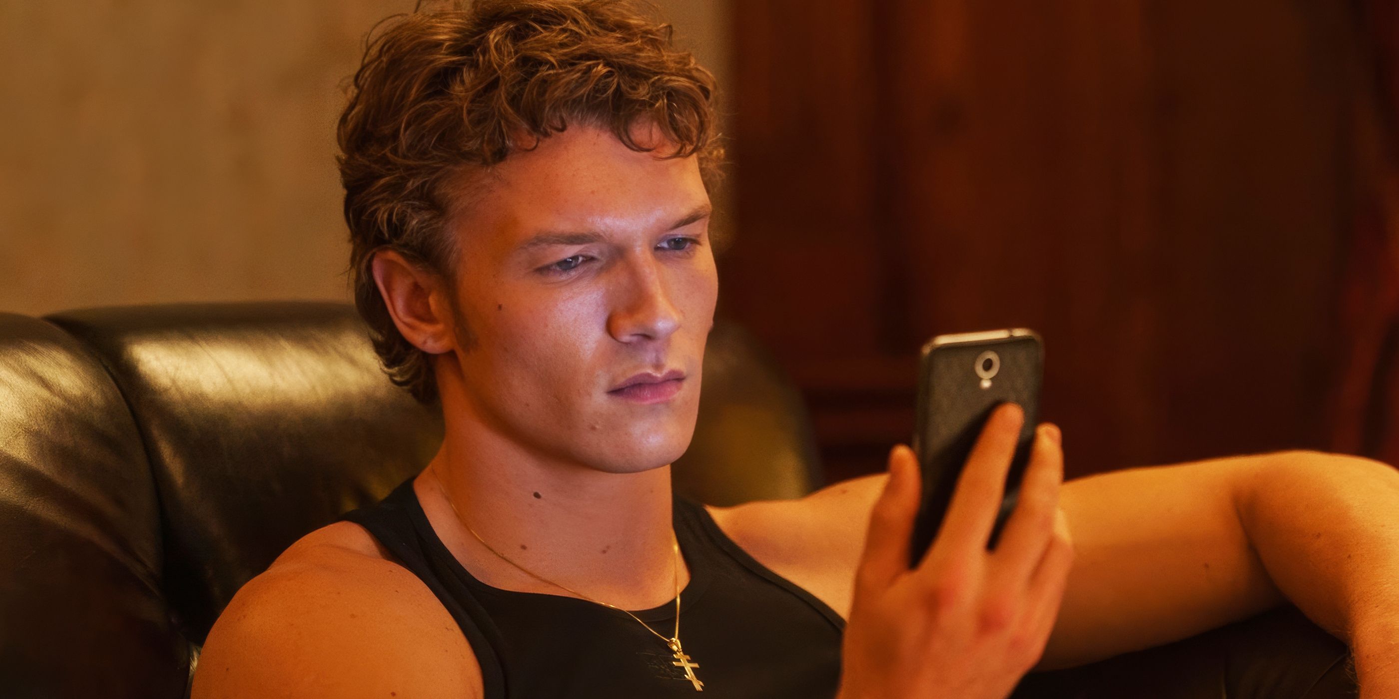 Connor Storrie's Ilya looking at his phone in Episode 5 of Heated Rivalry