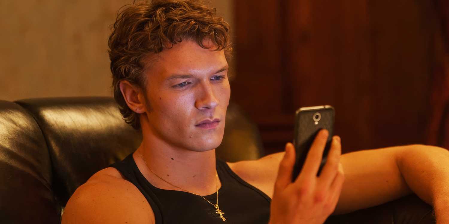 Connor Storrie's Ilya looking at his phone in Episode 5 of Heated Rivalry