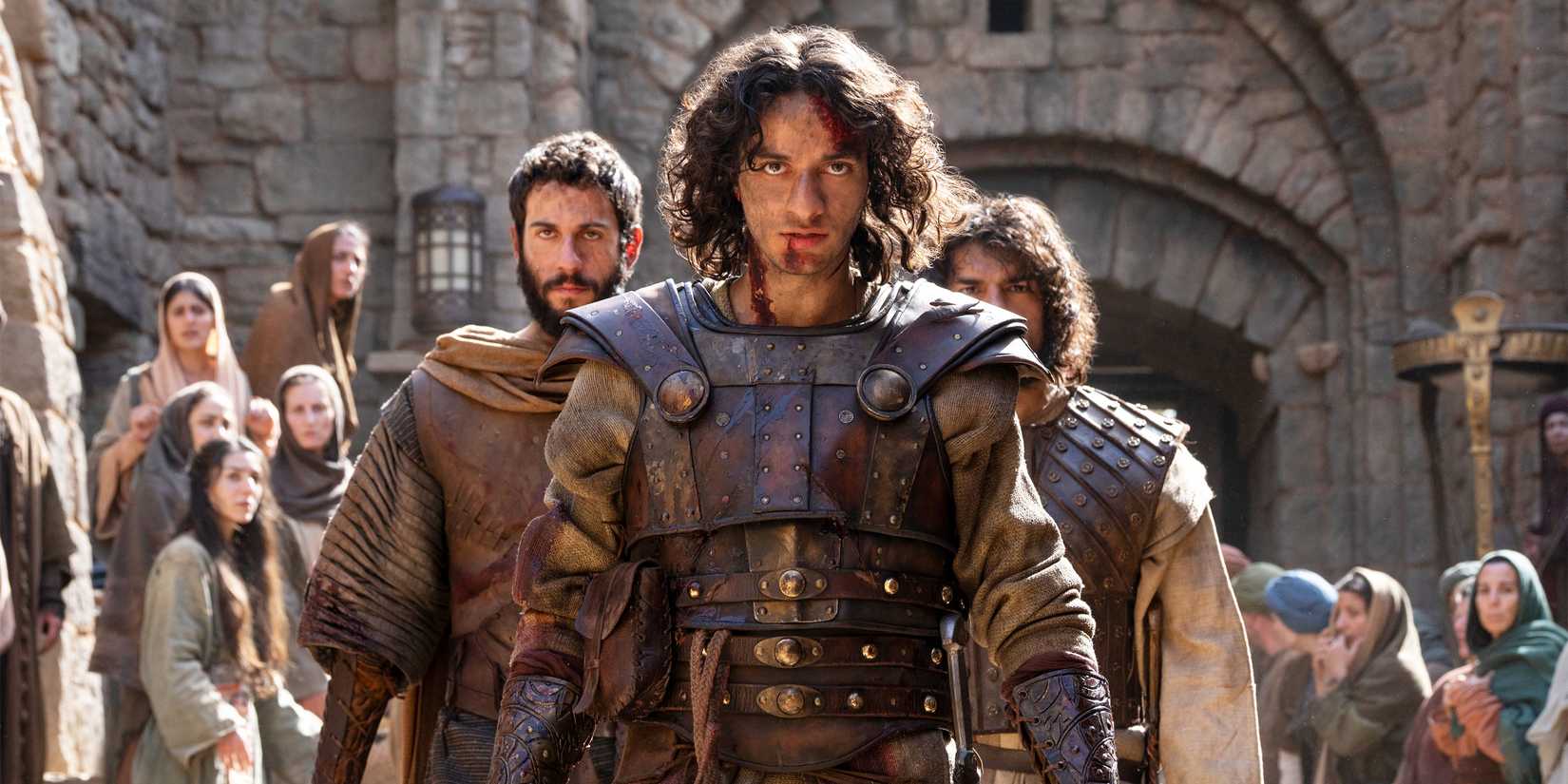 David in armor with blood trickling from his lip, flanked by two other soldiers, walks determined in House of David Season 2