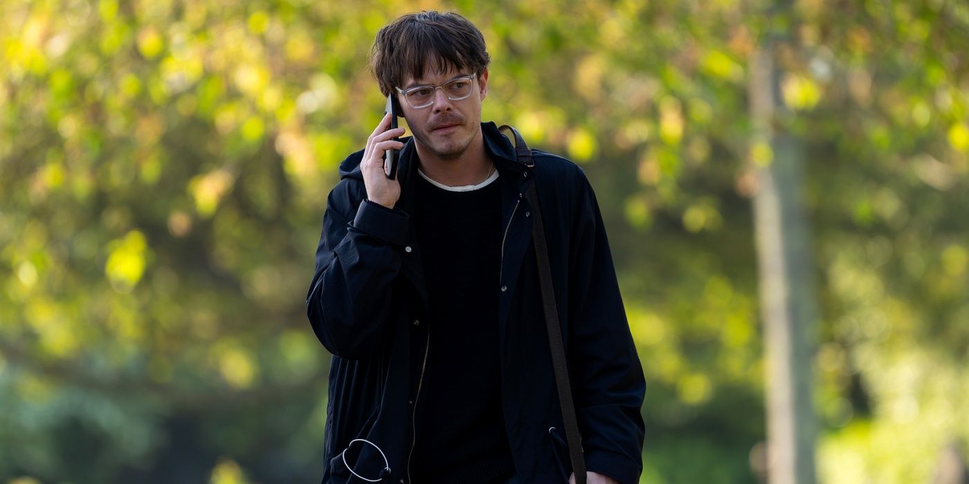 Charlie Heaton as James Dycker walking outside while talking on his cell phone in Industry Season 4
