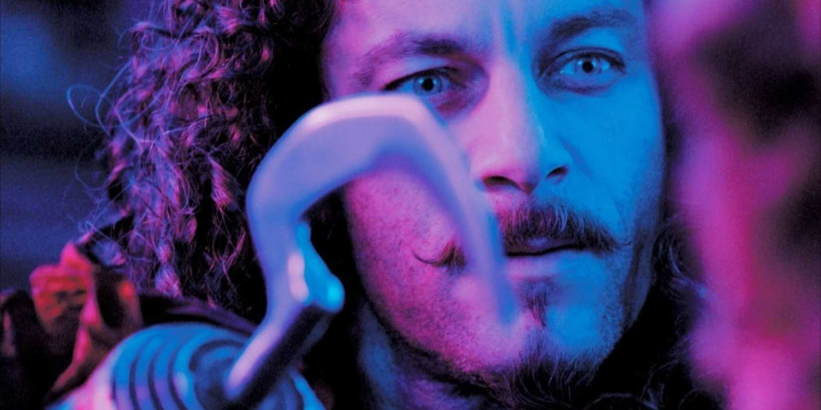 Jason Isaacs as Captain Hook staring intently at a child in Peter Pan, 2003