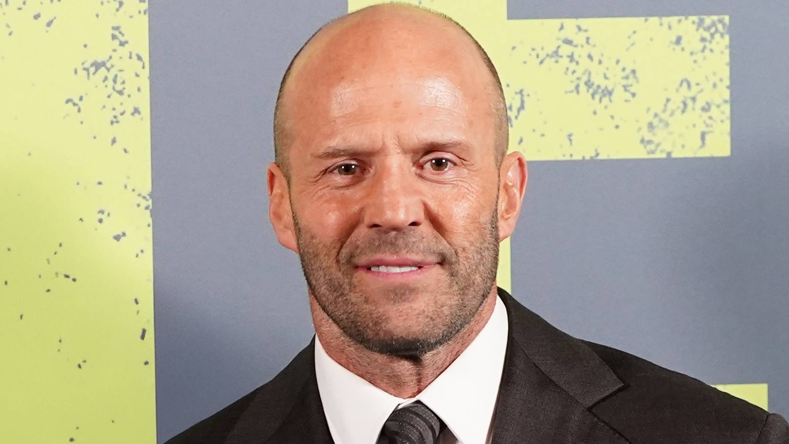 Jason Statham grinning on the red carpet