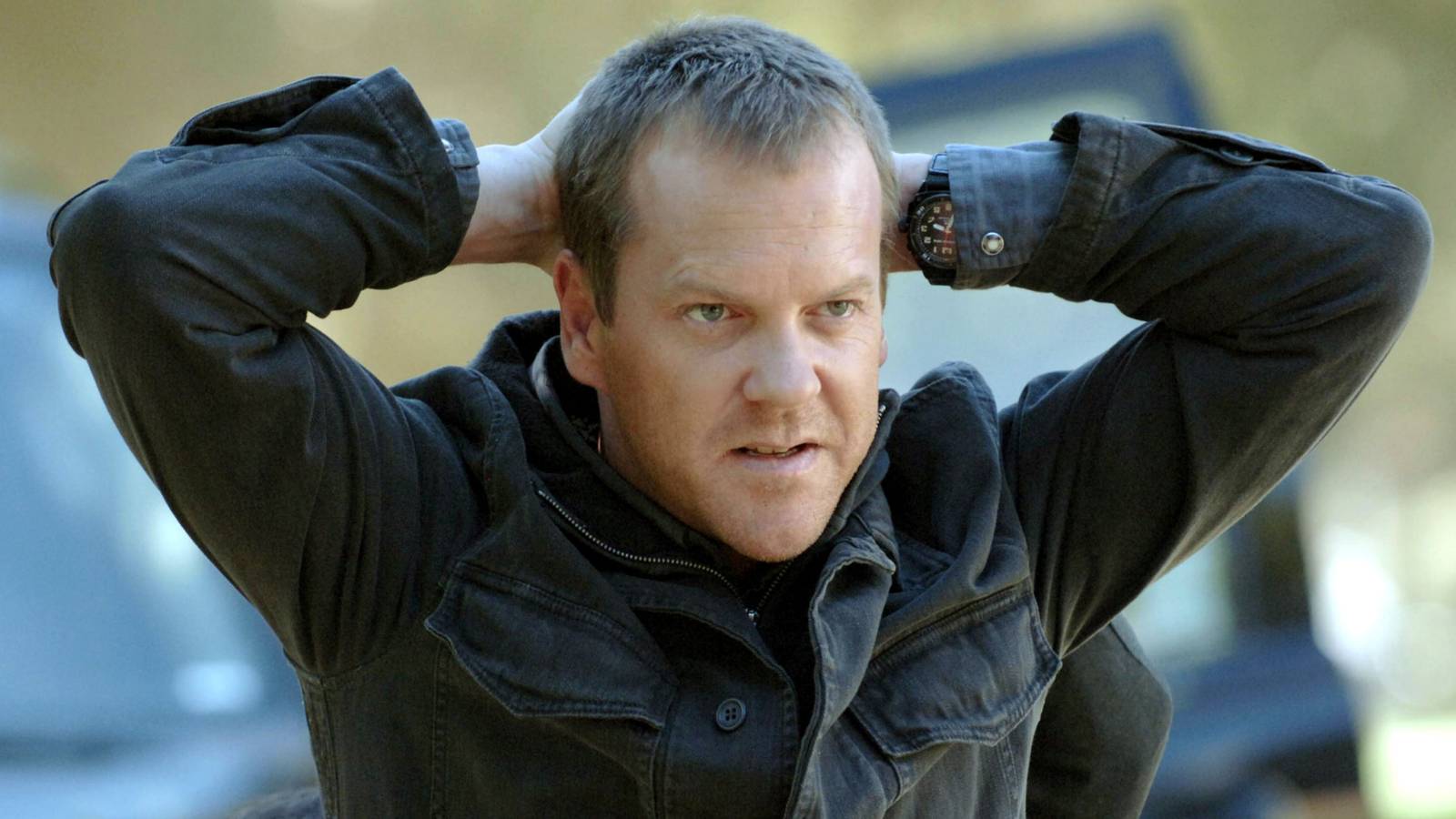Kiefer Sutherland's Jack Bauer kneeling with his hands behind his head in 24