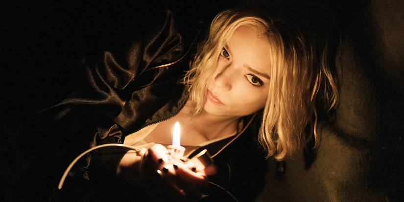 Anya Taylor Joy uses her lighter to illuminate her surroundings in Lucky